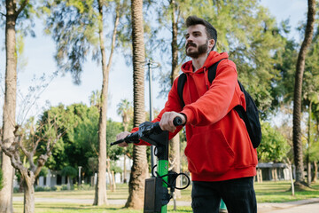 Electric scooter, Young man goes to work using electric scooter, Sunny day, a new mode of transportation is electric scooter