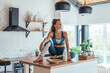 © undrey - Young woman in sports clothes in the kitchen at home