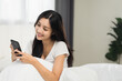 © Chanakon - Pretty asian woman using smart phone on bed to social media at home in the morning. Lifestyle of young beautiful female using mobile phone to network internet online on the bed