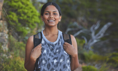 Poster - Getting fresh air often is important. Shot of a young woman enjoying a sunset hike on a mountain range outdoors.