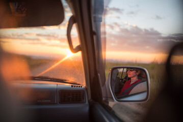 Wall Mural - Driving on RN7 (Nationale Route 7) at Isalo National Park at sunset, Southwestern Madagascar