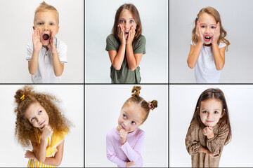 Wall Mural - Set of portraits of little cute emotional kids, boys and girls isolated on gray background. Education, emotions, childhood. Looking up