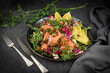 Super Sirtuin salad in a stylish black plate over black background