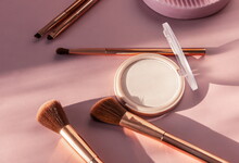 Face Powder And Brushes Makeup On A Pink Pastel Background,flat Layot,top View