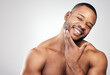 © Kay Abrahams/peopleimages.com - Grooming greatly improves your physical appearance. Studio portrait of a handsome young man posing against a white background.