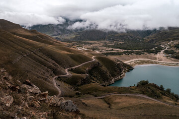 Wall Mural - mountain lake with turquoise water on a cloudy day. elbrus region