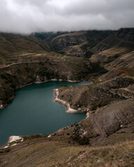 Wall Mural - mountain lake with turquoise water on a cloudy day. elbrus region