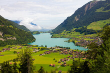 Lake, Mountains And Village. Aerial View On Village In Austria