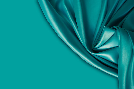 Wall Mural - Photography of beautiful wavy turquoise silk satin luxury cloth fabric with monochrome background design. 