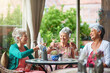 © Cecilie S/peopleimages.com - Celebrating a long and happy friendship. Cropped shot of a group of senior female friends enjoying a lunch date.