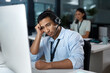 © Nicholas Felix/peopleimages.com - Rude callers really do my head in. Shot of a young man using a headset and looking depressed in a modern office.