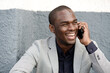 © mimagephotos - Close up african american man laughing and talking with cellphone
