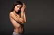 © LIGHTFIELD STUDIOS - woman in panties, with speak your mind lettering on arm, looking at camera isolated on dark grey