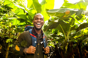 happy man hiking in jungle trees