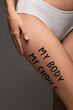 © LIGHTFIELD STUDIOS - partial view of woman in panties, with my body my choice lettering on hip isolated on dark grey