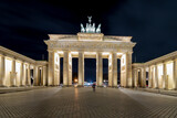 Fototapeta Paryż - Night cityscape of the famous city gate Brandenburger Tor in the evening, Neoclassical monument, One of the best-known landmarks of Germany, Located in the western part of the city centre of Berlin.