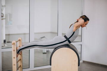 Wall Mural - Woman practising yoga with equipment