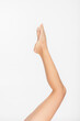 © LIGHTFIELD STUDIOS - partial view of slim and smooth female legs isolated on white