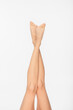 © LIGHTFIELD STUDIOS - partial view of fit female legs with smooth skin isolated on white