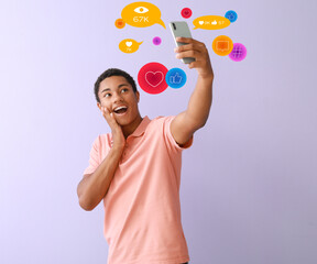 Canvas Print - Excited African-American teenage boy using mobile phone for social networking at home