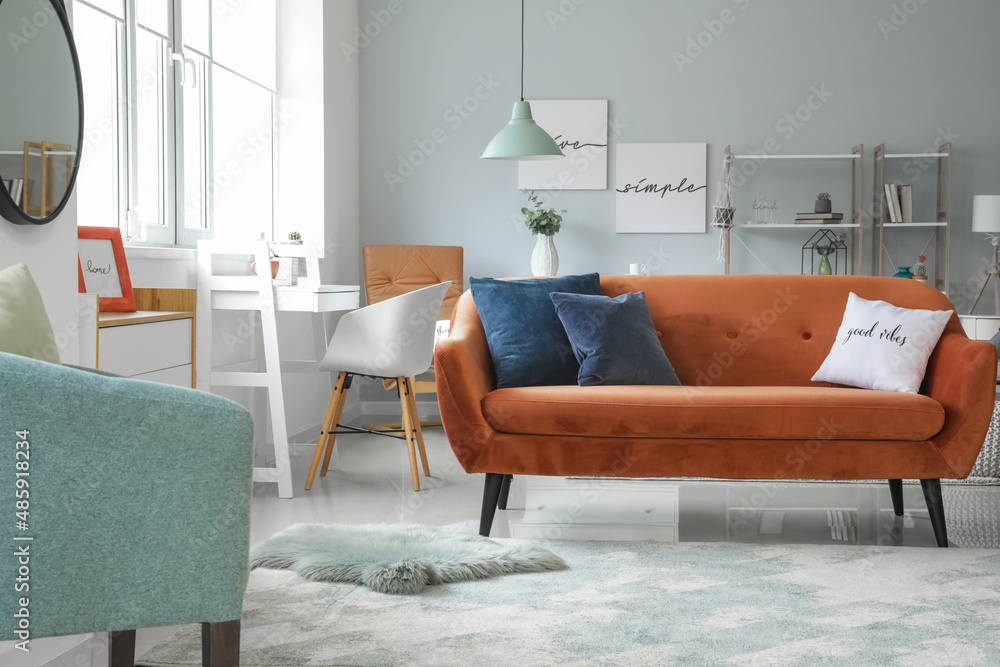 Interior of modern living room with stylish brown sofa
