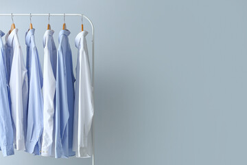 rack with clean shirts on grey background
