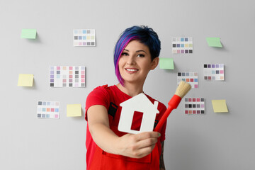 Sticker - Female painter with house figure and brush on light background