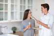 © BestForYou - Portrait of young couple in the kitchen with carrot juice. Healthy eating