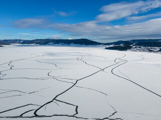 Aerial winter view of Batak Reservoir covered with ice, Bulgaria