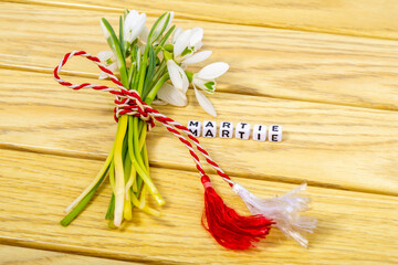 Sticker - A bouquet of snowdrops wrapped with a red and white string with copy space