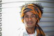 Close up portrait of young African American man with afro hairstyle and turban. Space for text.