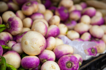  Fresh organic purple turnips in boxes on market shelves for sell