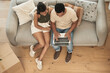 © Siphosethu F/peopleimages.com - Everywhere you go, is a chance to create new memories. Shot of a couple using a laptop at home.