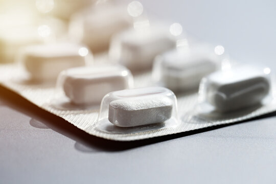 closeup of pills in blister pack. headache pills, painkillers, antibiotics or antidepressants tablet