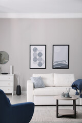 Wall Mural - Stylish living room interior with white sofa, armchair and small coffee table