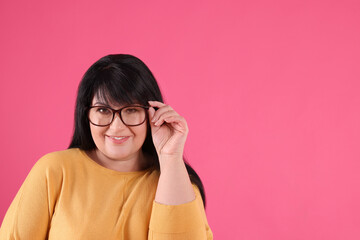 Sticker - Beautiful overweight mature woman with charming smile on pink background. Space for text