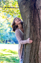 Young  Female Tree Hugger Embraces Her Favorite Old Tree In Her Yard