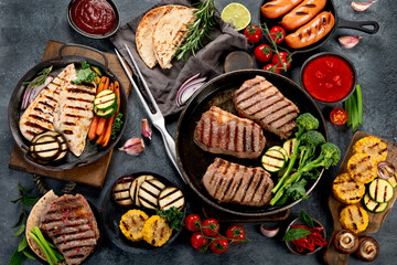 Wall Mural - Grilled barbecue meat assortment on dark background.