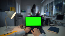 Pov Shot Of Businessman Typing On Laptop With Green Screen Late In Office