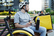 © blackday - Express delivery courier sitting on bench with thermos and cup of coffee.