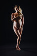 © katya - Photo shoot portrait of a pregnant nude woman in the studio. Nude photos
