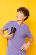 © Tatiana - guy with curly hair disposable black glasses yellow background