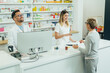© Zamrznuti tonovi - Two pharmacist giving prescription medications to senior female customer in a pharmacy
