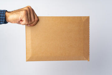 Poster - Male hand holding parcel post against white background