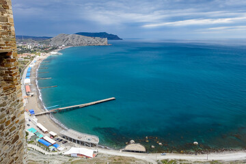 Crimea - May 2021. A line of beaches in the city of Sudak. View from the Genoese fortress on the Sudak Bay. Sudak.