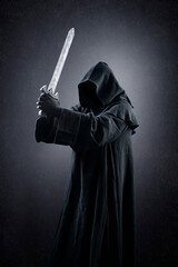 Warrior with hooded cape and medieval sword over dark misty background