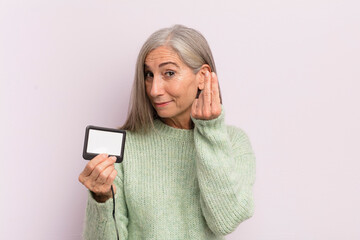 Wall Mural - middle age woman making capice or money gesture, telling you to pay. vip pass concept