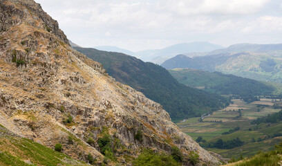 Sticker - Distant mountain views of Blencathra, Bleaberry Fell, Grange Fell and Seatoller from the rocky crags of below Base Brown in the English Lake District, UK.