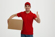 © Drobot Dean - Young caucasian male courier with cardboard box