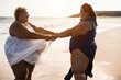© DisobeyArt - Curvy women dancing on the beach having fun during summer vacation - Focus on faces